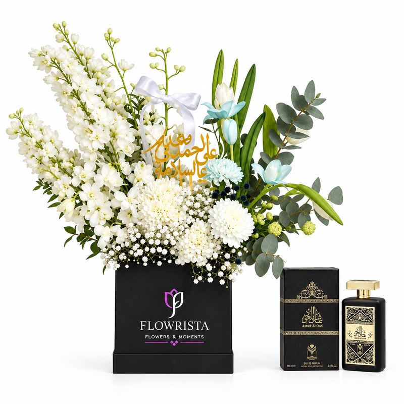 Ashek Al Oud perfume by Almas beside white and blue get-well flowers in a black Flowrista box