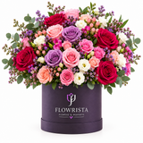Red, pink, lavender and white roses in a purple Flowrista box