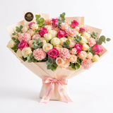 Flowrista pink and cream roses with pink carnations eucalyptus ivory wrapping and pink satin bow