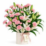 Pink carnations and white lilies in a cream flower box with blush satin bow and Flowrista tag