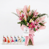 Mini Summer Collection perfume set beside pink lilies and eucalyptus with pink wrapping and Flowrista tag