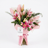 Fresh pink lily bouquet with eucalyptus in pink wrapping and ribbon with Flowrista Flowers & Moments gift tag