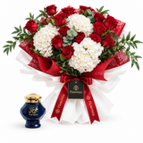 Omani Bakhour blue jar with gold lid beside Flowrista red rose and white hydrangea bouquet